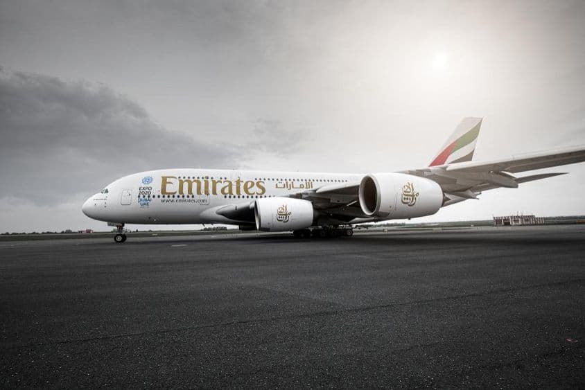 Emirates plane standing on the runway.