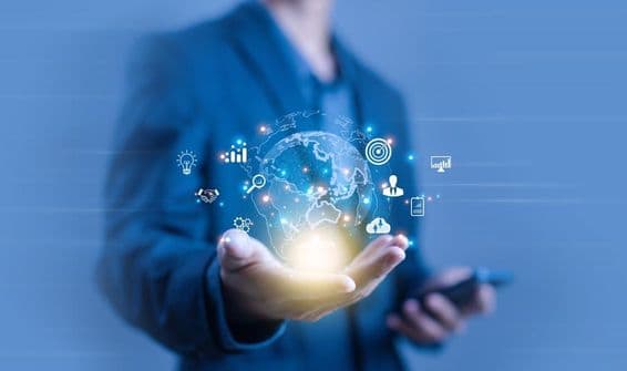 A person holding a globe-shaped digital projection.