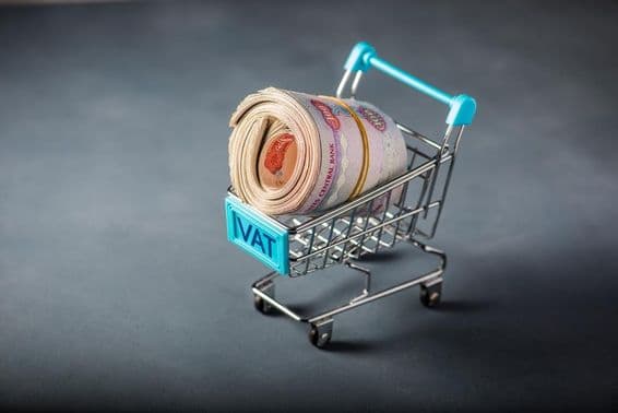 Small shopping cart with a bundle of dirham and the word 'tax' at the front.