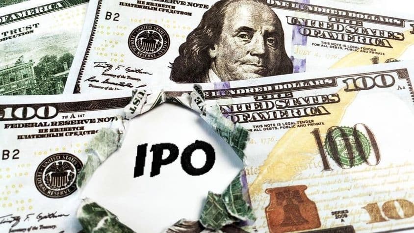 A piece of paper with 'IPO' on top of US 100 dollar bills.