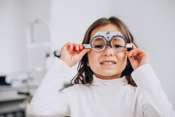 Visually impaired girl wearing trial glasses at an optician.
