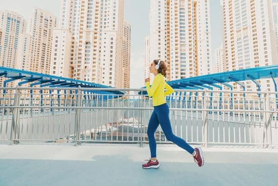 Female runner with skyscrapers in the background.