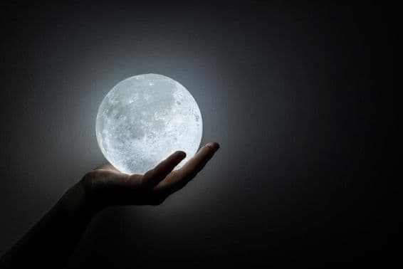 A hand holding the moon.