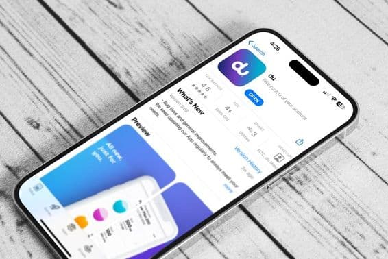 A phone on a table, running the du mobile app.