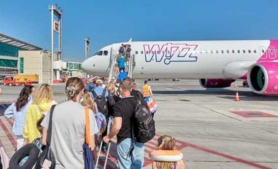 Passengers boarding a Wizz Air airplane.