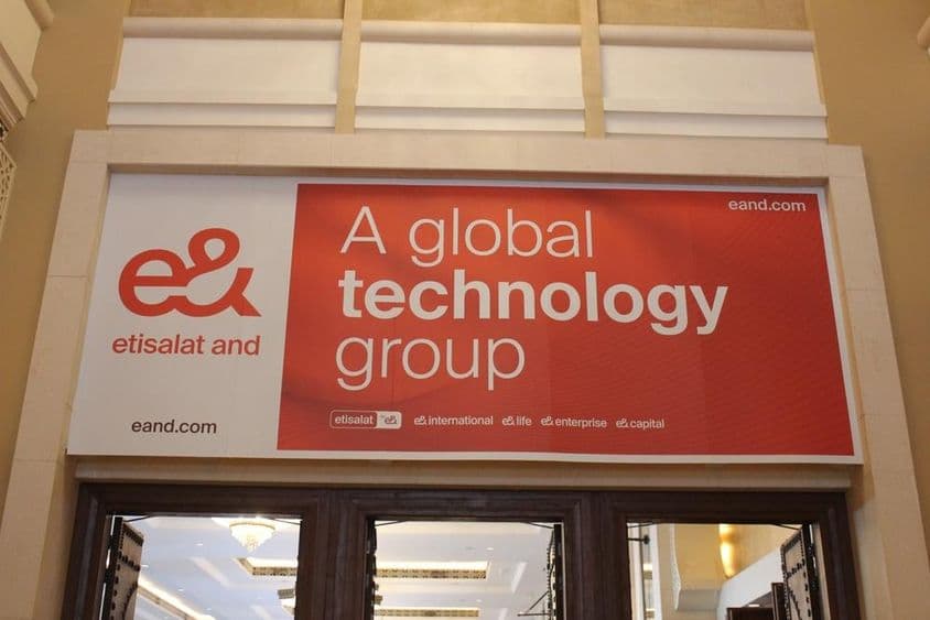 Etisalat company advertisement above a storefront with glass entrance visible.