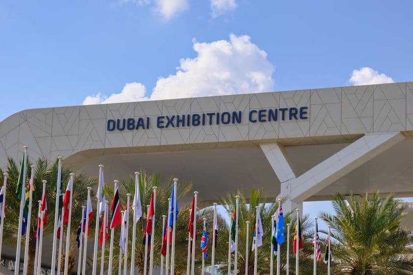 Dubai Exhibition Centre with flags in the foreground.