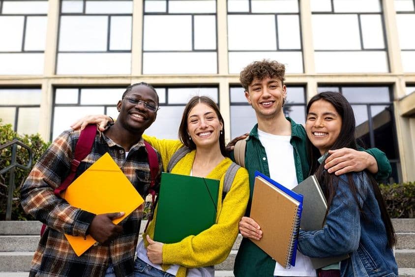 Students are in the picture holding folders.