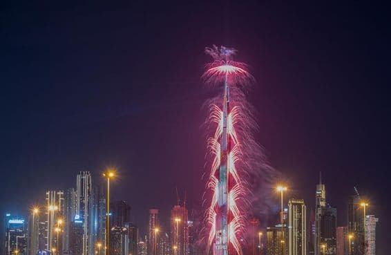 Burj Khalifa New Year's Eve fireworks with other illuminated skyscrapers.