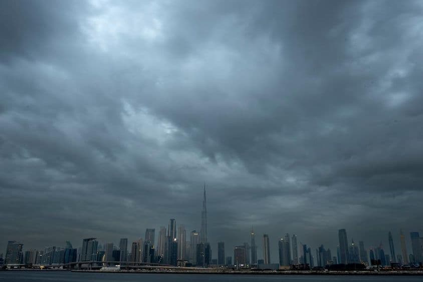 Overcast sky with a background of skyscrapers, Burj Khalifa in the center.