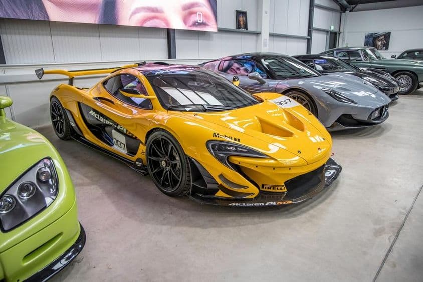 McLaren and other cars parked in a garage.