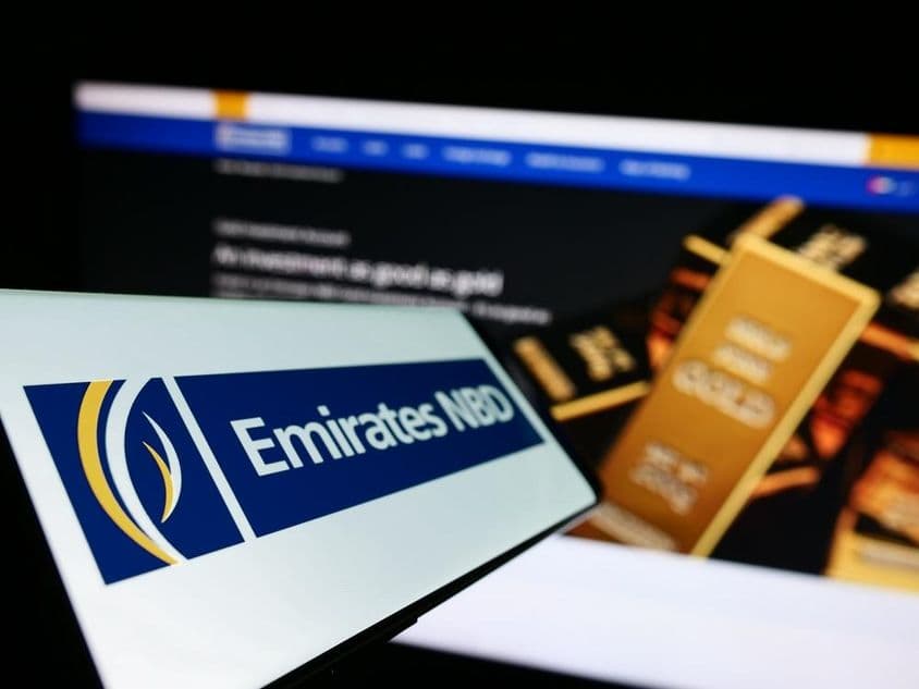 Emirates NBD signage foreground, background showing an investment gold bar.
