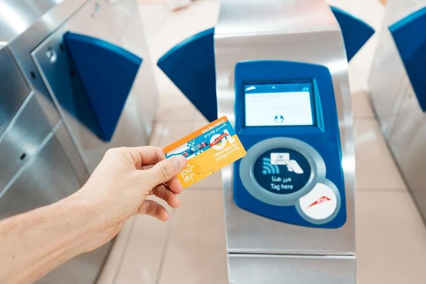 A person holding a limited 10th-anniversary Nol card in use on the metro.