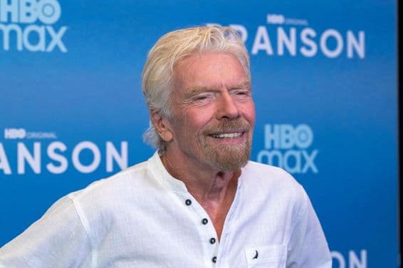Richard Branson in front of a blue background.