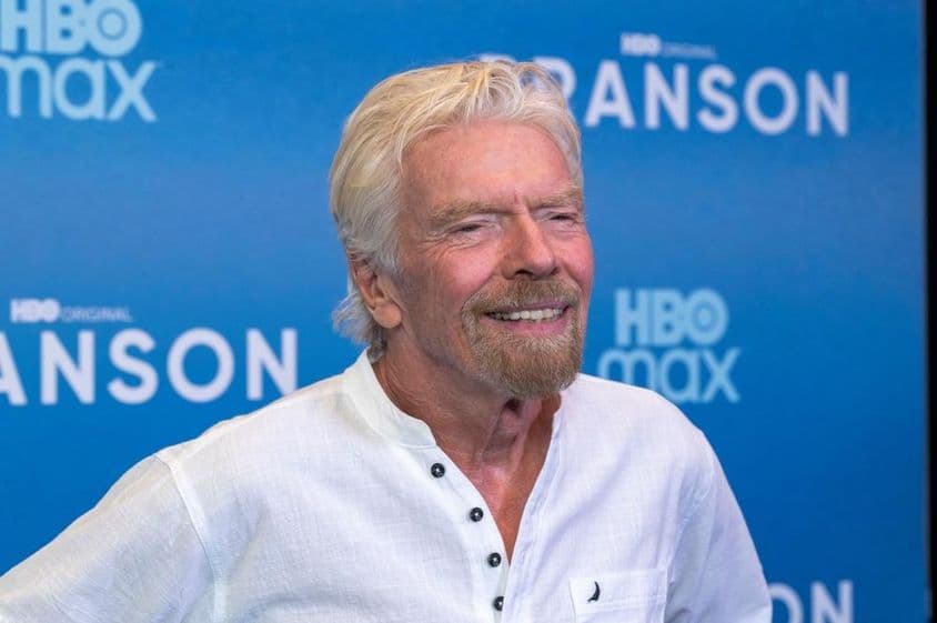 Richard Branson in front of a blue background.