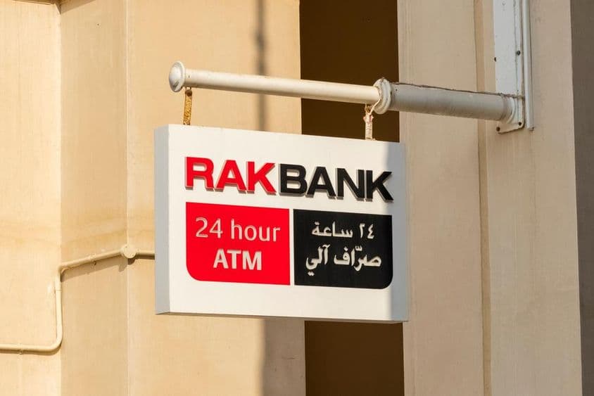 RAKBANK ATM sign in red and partially black text.