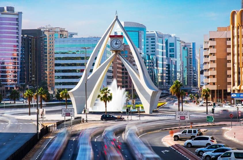Amazing Clock Tower in Dubai with houses in the background.