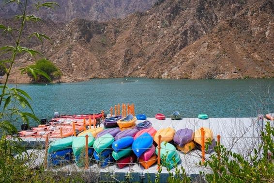 Kayaks in front of Al Rafisah Dam with a few inflatable boats.