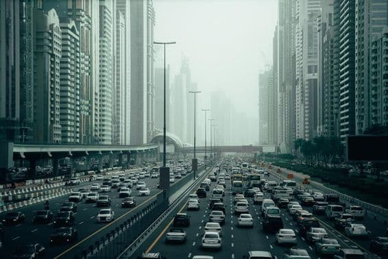 Dubai skyline view from a road, full of cars, huge traffic jam.