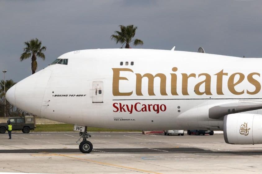 Emirates Boeing 777 with sky cargo signage visible.