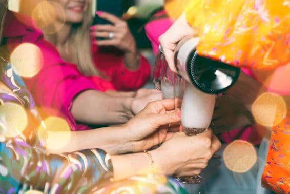 People drinking champagne in a club.