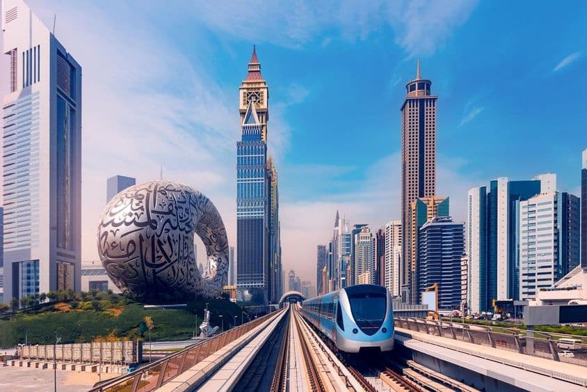 Dubai metro with skyscrapers in the background, museum of the future on the left.