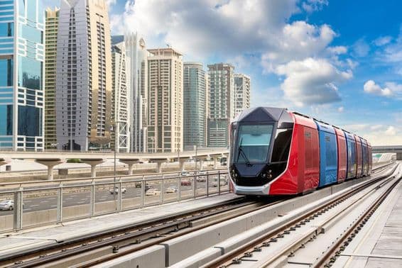 Dubai tram with skyscrapers in the background.