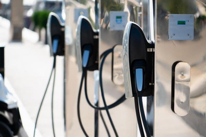 Tesla chargers lined up next to each other.