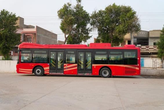 A red Dubai bus is shown while parked.