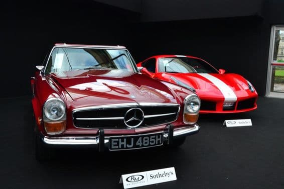 A Mercedes and a Ferrari at a Sotheby’s auction.