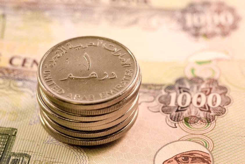 UAE currency: 1000 dirham bill and 1 dirham coin.