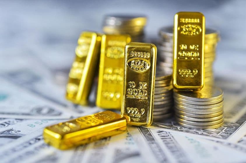 Investment gold and a handful of change on dollars.