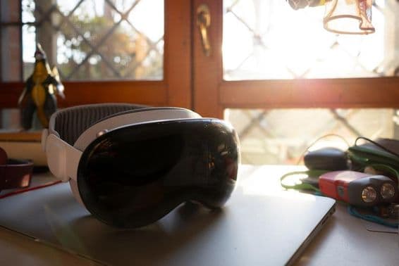 Apple Vision Pro lying on a notebook on a table.