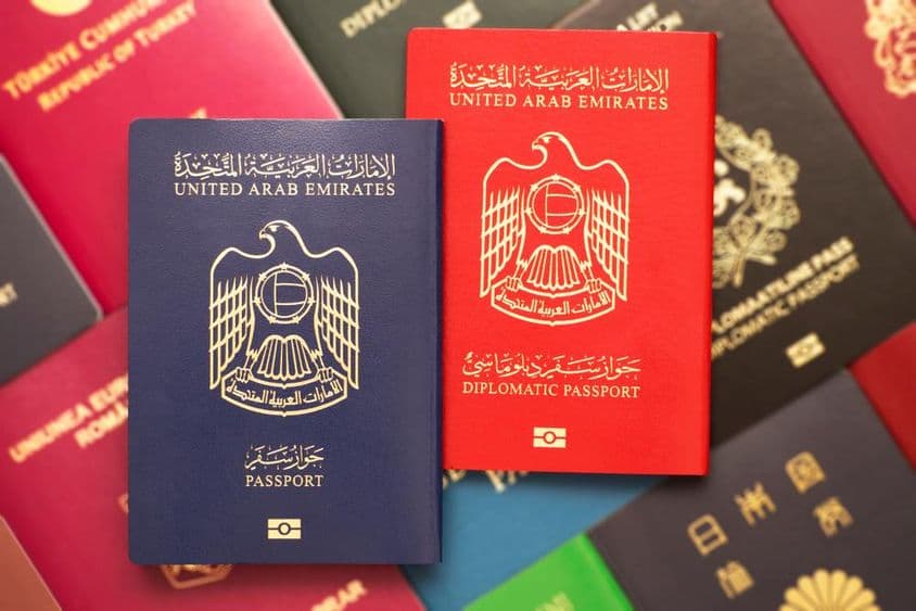 Passports stacked with UAE passports on top.