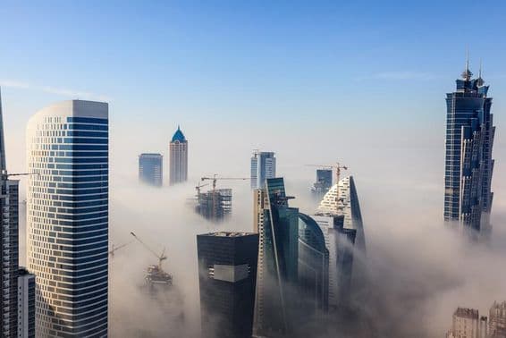 Dubai skyscrapers shrouded in fog.
