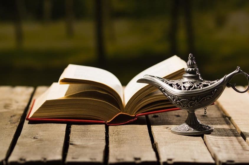 Open book and an old lamp.