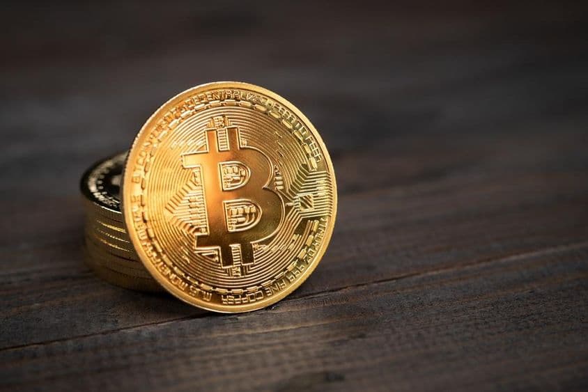 Bitcoin coins on a table.
