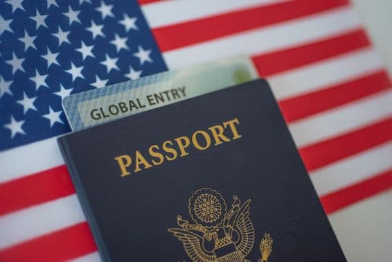 American passport with an American flag in the background.