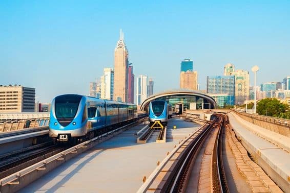 Dubai metro cars with skyscrapers in the background.
