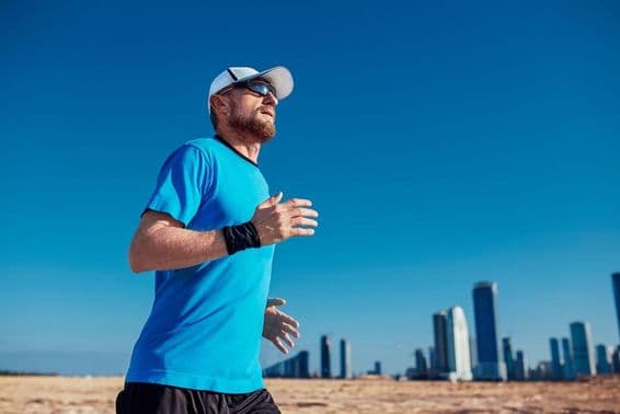 Dubai Triathlon, a man running with skyscrapers in the background.