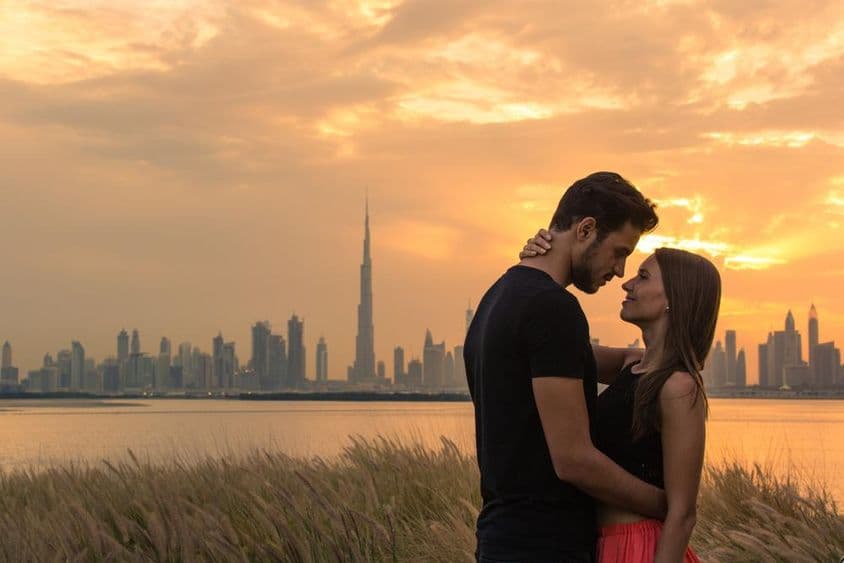 Young couple with Dubai skyline in the background.