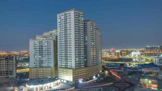 Ajman cityscape with rooftops and towers.