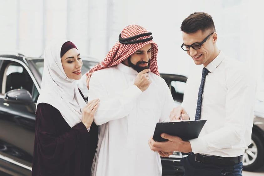 Arab man reading vehicle documents.