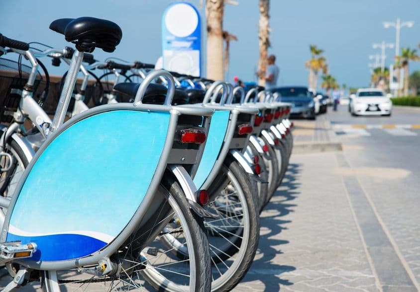 Dubai bicycles neatly placed in a rack.
