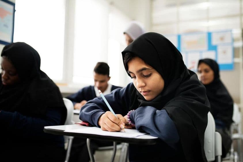 Muslim children studying in a classroom