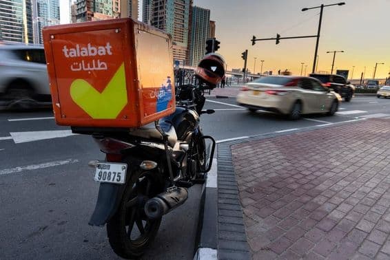 Talabat motorbike parked on the roadside.