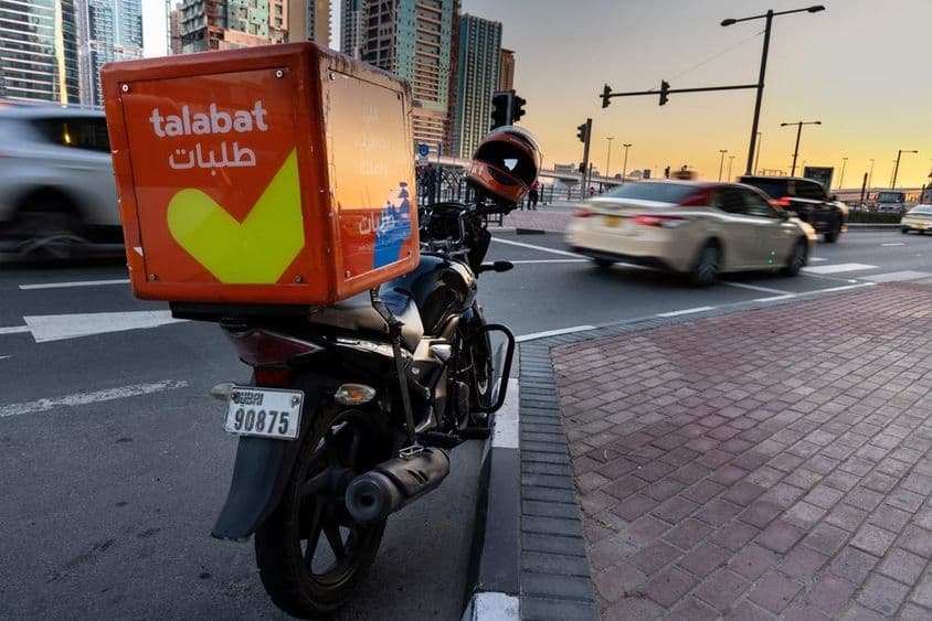Talabat motorbike parked on the roadside.