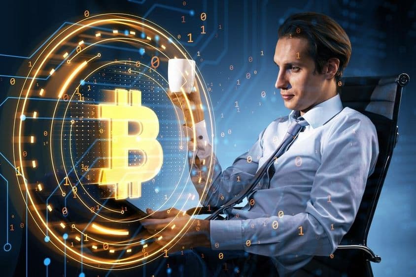 Businessman holding a coffee mug looks at the Bitcoin price.