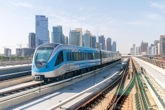 Dubai metro train with buildings in the background.