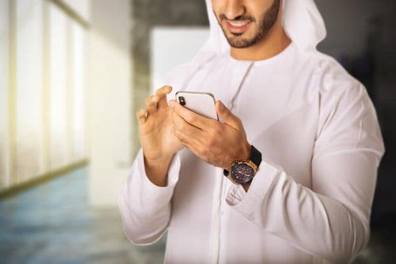 Arab man using a phone.